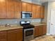 Kitchen with wood cabinets, stainless steel appliances, and granite countertops at , Las Vegas, NV 89148
