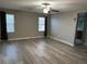 Spacious living room with modern ceiling fan and plank flooring at , Las Vegas, NV 89148