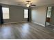 Bright living room with hardwood floors, ceiling fan and natural light streaming through the windows at , Las Vegas, NV 89148