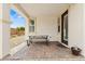 Covered outdoor patio, perfect for relaxing or entertaining with a modern bench and paver flooring at 10127 Knotty Skye Ave, Las Vegas, NV 89166