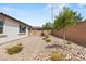 Spacious backyard features gravel landscaping, a block wall, and small plants at 10127 Knotty Skye Ave, Las Vegas, NV 89166