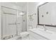 Bathroom featuring tiled standing shower, toilet, and vanity with a large mirror at 10127 Knotty Skye Ave, Las Vegas, NV 89166