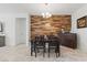 Bright dining room with wood accent wall, chandelier and decorative cabinet, offering stylish ambiance at 10127 Knotty Skye Ave, Las Vegas, NV 89166