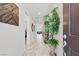 Spacious entryway showcases wood-look tile, decorative plant, and an inviting view into the home at 10127 Knotty Skye Ave, Las Vegas, NV 89166