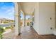 Welcoming front porch with stone pillars, wrought iron seating, and stylish brick pavers at 10127 Knotty Skye Ave, Las Vegas, NV 89166