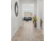 Bright hallway featuring wood-look tile flooring leading into the living area with ample natural light at 10127 Knotty Skye Ave, Las Vegas, NV 89166