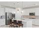 Modern kitchen with white cabinets, stainless steel appliances, and an island with bar stools at 10127 Knotty Skye Ave, Las Vegas, NV 89166