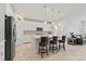 Open kitchen featuring a center island with seating, stainless steel appliances, and neutral countertops at 10127 Knotty Skye Ave, Las Vegas, NV 89166