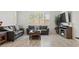 Cozy living room with comfortable seating, large windows, and natural light at 10127 Knotty Skye Ave, Las Vegas, NV 89166