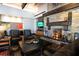 Cozy lounge area with a stone fireplace, comfortable seating, and stylish decor at 10127 Knotty Skye Ave, Las Vegas, NV 89166