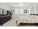 Bright main bedroom featuring a television, modern decor, and light wood flooring at 10127 Knotty Skye Ave, Las Vegas, NV 89166