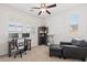 Bright home office with a modern desk setup, comfortable seating, and large windows at 10127 Knotty Skye Ave, Las Vegas, NV 89166