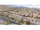 Expansive aerial view showcasing a dense neighborhood nestled against the backdrop of scenic mountains at 10356 Addie De Mar Ln, Las Vegas, NV 89135