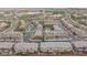 High angle aerial view of a community featuring tree lined streets, community pool, and well-kept landscaping at 10356 Addie De Mar Ln, Las Vegas, NV 89135