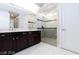 Beautiful bathroom featuring a double sink vanity and glass enclosed shower with seat at 10356 Addie De Mar Ln, Las Vegas, NV 89135