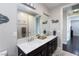 Bathroom features a double sink vanity, framed mirrors, and decorative lettering on the wall at 10356 Addie De Mar Ln, Las Vegas, NV 89135