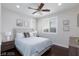 This bedroom boasts natural lighting, a ceiling fan, and warm toned hardwood floors at 10356 Addie De Mar Ln, Las Vegas, NV 89135