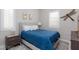 Cozy bedroom with a queen size bed, shutters, and decorative dragonfly art at 10356 Addie De Mar Ln, Las Vegas, NV 89135
