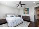 Bedroom features hardwood floors, a ceiling fan, and 2 bedside lamps and tables at 10356 Addie De Mar Ln, Las Vegas, NV 89135