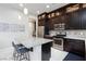 Stylish kitchen with stainless steel appliances, granite countertops, and an island with bar seating at 10356 Addie De Mar Ln, Las Vegas, NV 89135