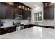 Spacious kitchen featuring granite countertops, stainless steel appliances, and abundant cabinet space at 10356 Addie De Mar Ln, Las Vegas, NV 89135