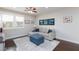 Cozy living room featuring a comfortable couch, ceiling fan, and an abundance of natural light at 10356 Addie De Mar Ln, Las Vegas, NV 89135
