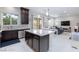 Open-concept living space with modern kitchen, dining area, and comfortable seating area at 10356 Addie De Mar Ln, Las Vegas, NV 89135