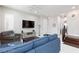Comfortable living room with plush seating, modern entertainment center, and neutral decor at 10356 Addie De Mar Ln, Las Vegas, NV 89135