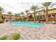 Community pool surrounded by palm trees, lounge chairs, and manicured landscaping at 10356 Addie De Mar Ln, Las Vegas, NV 89135
