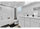 Bright bathroom offers double sinks, a tub with shower, and modern fixtures at 10415 Sadie Blake Ave, Las Vegas, NV 89166