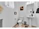 Powder room with a pedestal sink and neutral decor at 10415 Sadie Blake Ave, Las Vegas, NV 89166