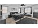 Bedroom with neutral walls, dark furniture, and a large window at 10415 Sadie Blake Ave, Las Vegas, NV 89166