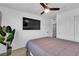 Bright bedroom with ceiling fan, carpeted floor, TV and closet with sliding doors at 10415 Sadie Blake Ave, Las Vegas, NV 89166