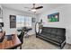 Bedroom with a ceiling fan, writing desk, and a full-sized futon at 10415 Sadie Blake Ave, Las Vegas, NV 89166