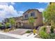 Inviting two-story home with a well-manicured front yard and a charming brick driveway at 10415 Sadie Blake Ave, Las Vegas, NV 89166