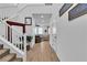 Bright foyer featuring a staircase, wood-look tile flooring, and decorative wall art at 10415 Sadie Blake Ave, Las Vegas, NV 89166