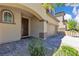 Charming home featuring a well-maintained front yard with stone pavers, trees, and a two-car garage at 10415 Sadie Blake Ave, Las Vegas, NV 89166