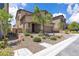 Charming two-story home with a landscaped front yard and a brick-paved driveway at 10415 Sadie Blake Ave, Las Vegas, NV 89166