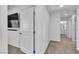 Hallway with neutral carpet leading to a bathroom at 10415 Sadie Blake Ave, Las Vegas, NV 89166