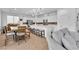 Bright, open kitchen with white cabinets, stainless steel appliances, island seating, and dining area at 10415 Sadie Blake Ave, Las Vegas, NV 89166