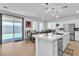 Stylish kitchen with stainless steel appliances, a quartz countertop island, and access to the backyard at 10415 Sadie Blake Ave, Las Vegas, NV 89166