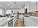Open kitchen featuring white cabinets, modern appliances, and center island at 10415 Sadie Blake Ave, Las Vegas, NV 89166