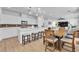 Open-concept kitchen with white cabinets, stainless steel appliances, and a breakfast bar with seating at 10415 Sadie Blake Ave, Las Vegas, NV 89166