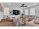 Cozy living room with modern furniture, large TV, ceiling fan, and plenty of natural light at 10415 Sadie Blake Ave, Las Vegas, NV 89166