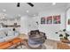 Open living space with neutral decor, modern art, and seamless flow to the kitchen at 10415 Sadie Blake Ave, Las Vegas, NV 89166