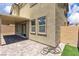 Covered patio with brick flooring and access to artificial grass backyard at 10415 Sadie Blake Ave, Las Vegas, NV 89166