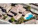 Gorgeous aerial shot of a home with a pool and spa combo, surrounded by lush greenery at 10520 Maystar Ln, Las Vegas, NV 89135