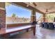 A stunning covered back patio with stone pillars and ceiling fans offers a comfortable space at 10520 Maystar Ln, Las Vegas, NV 89135