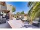 This covered patio area with multiple seating areas and lush landscaping makes it an outdoor oasis at 10520 Maystar Ln, Las Vegas, NV 89135