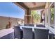 A covered back patio with views of a palm tree offers a relaxing outdoor living space at 10520 Maystar Ln, Las Vegas, NV 89135